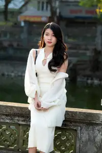 Elegant Beauty in Pristine White Dress Under Golden Afternoon Sun 1000027006-3