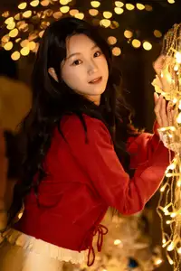 Radiant Smile Girl in Red Amidst Twinkling Lights: Warm Beauty for Festive Season-1