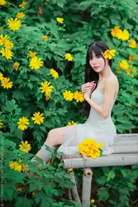 Graceful Young Woman in White Dress Amidst Vibrant Yellow Flowers 1000026997-4