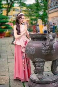Graceful Woman in Pink Dress Amidst Ancient Heritage Charm 1000025280-8