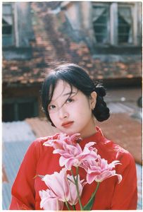 Vintage Ao Dai Beauty: Elegant Vietnamese Woman with Flowers in a Nostalgic Setting-0