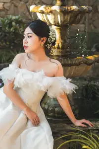 Elegant Bride Plays White Piano Amidst Lush Greenery: A Serene Wedding Moment-2