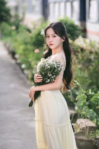 Serene Natural Beauty: Gentle Girl in Cream Dress Amidst Lush Garden-1