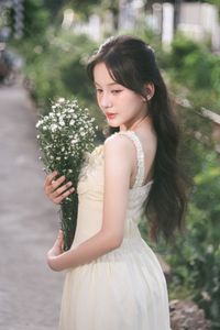 Serene Natural Beauty: Gentle Girl in Cream Dress Amidst Lush Garden-14