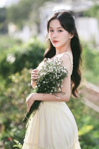 Serene Natural Beauty: Gentle Girl in Cream Dress Amidst Lush Garden-6