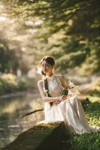 Serene Vietnamese Beauty in White Ao Dai with Lilies: A Golden Hour Portrait 1000025192-3