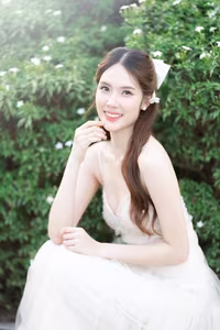 XVG No.19: Radiant Bride: Beautiful Woman in Elegant White Gown with a Joyful Smile in Lush Green Setting.-18