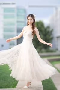 XVG No.19: Radiant Bride: Beautiful Woman in Elegant White Gown with a Joyful Smile in Lush Green Setting.-24