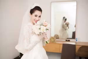 Witness Do Thi Ha's enchanting transformation into a radiant princess in a stunning white wedding gown-0