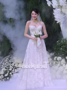 Witness Do Thi Ha's enchanting transformation into a radiant princess in a stunning white wedding gown-9