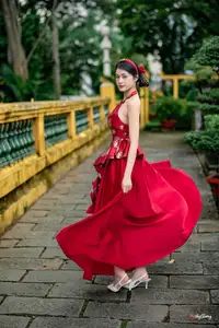 Elegant Asian Beauty in Red Dress Shines Gracefully Amidst a Traditional Garden 1000024509-6