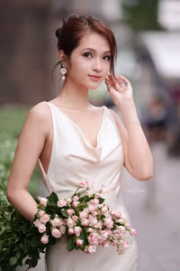 VGU No.11: Elegant Charm: A Woman's Grace in White Gown and Delicate Rose Bouquet-9