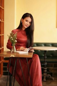 Discover Vietnamese Ao Dai Beauty: Elegant, Graceful Girl in a Cafe Setting-3