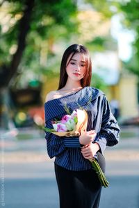 Elegant Beauty Charming Vietnamese Girl with Fresh Flowers on Street Captivating Street Fashion Style-7