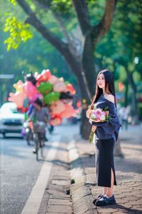Elegant Beauty Charming Vietnamese Girl with Fresh Flowers on Street Captivating Street Fashion Style-2