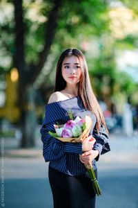 Elegant Beauty Charming Vietnamese Girl with Fresh Flowers on Street Captivating Street Fashion Style-8