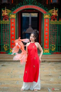 Vietnamese Cultural Beauty: Girl in Red Ao Dai & Traditional Lion Dance Prop-0
