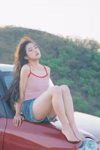 VGU No.128: Summer vibes: Young woman relaxed on a red car, captivating free spirit-8