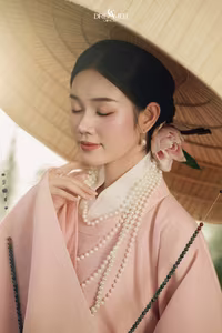 XVG No.50: Elegant Vietnamese Woman in Pink Traditional Dress, Conical Hat, Serene Beauty.-0
