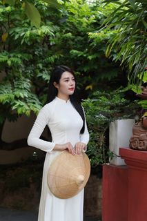 Elegant Vietnamese Woman in White Ao Dai Embracing Spirit of Independence-4