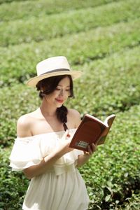 Serene Girl Embracing Nature & Book in Lush Green Tea Hill-0