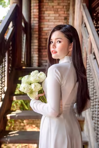 VGU No.69: Graceful Vietnamese beauty in pristine white Ao Dai with pure lotus, exuding captivating Asian charm.-1