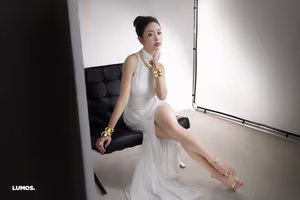 VGU No.53: Elegant beauty in a pristine white dress, posing glamorously on a luxurious black chair. Explore the sophisticated style of the modern woman.-0