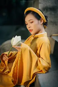Discover the Graceful Beauty of a Vietnamese Woman in Radiant Yellow Ao Dai with Pure Lotus 1000025235-5