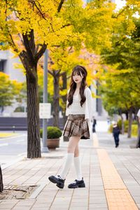 Young Asian Girl in Plaid Skirt Embracing Autumn Foliage-19