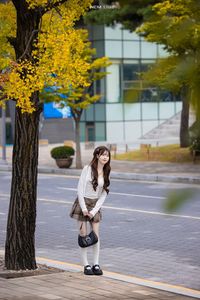 Young Asian Girl in Plaid Skirt Embracing Autumn Foliage-12