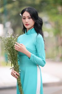 Vietnamese Ao Dai Beauty: Graceful Girl with Flowers.-1