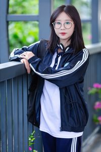 Radiant Youth: Girl in Uniform Playfully Blowing Bubbles in Lush Greenery 1000019736-7