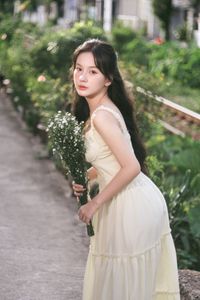 Graceful Girl in Light Yellow Dress with White Flowers, Ethereal Beauty in Nature-0