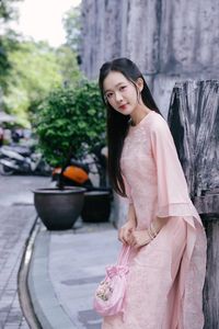 Elegant Woman in Pink Ao Dai at Hanoi Grand Cathedral - Vietnamese Cultural Charm-0
