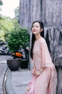 Elegant Woman in Pink Ao Dai at Hanoi Grand Cathedral - Vietnamese Cultural Charm-1