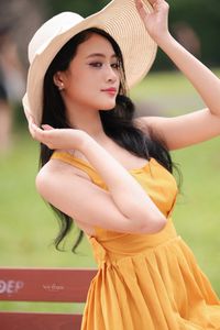 Charming Girl in Yellow Dress with Wide-Brim Hat Outdoors-1