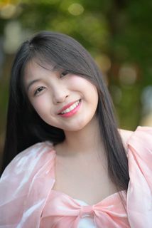 Radiant smile of a young, elegant Vietnamese girl in a pink and white dress.-15