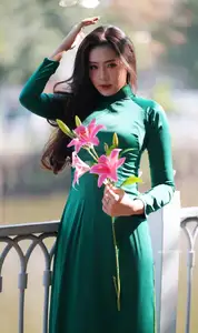 Vietnamese Grace: Elegant Woman in Green Ao Dai with Pink Lotus Flower 1000025232-16
