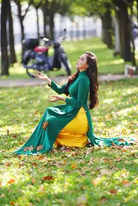 Vietnamese Grace: Elegant Woman in Green Ao Dai with Pink Lotus Flower 1000025232-8