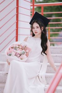 Beautiful Female Graduate Embraces Success at Graduation Ceremony-3