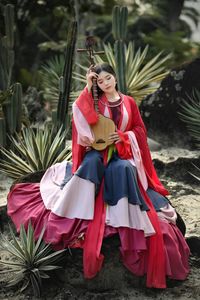 Traditional Vietnamese Beauty: Young woman with ancient instrument, immersed in culture and music.-2