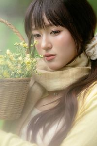 Pure Young Woman with Vibrant Yellow Flowers: Natural Beauty in a Lush Green Setting 1000019709-10