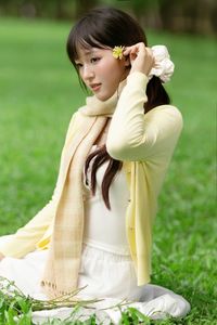 Pure Young Woman with Vibrant Yellow Flowers: Natural Beauty in a Lush Green Setting 1000019709-1