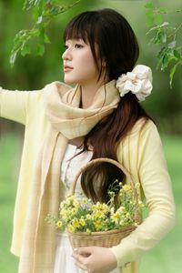Pure Young Woman with Vibrant Yellow Flowers: Natural Beauty in a Lush Green Setting 1000019709-6