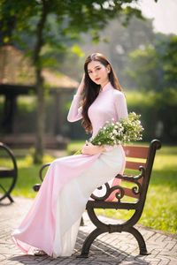 Elegant Vietnamese Woman in Pink Ao Dai Gracing a Sunny Park-8