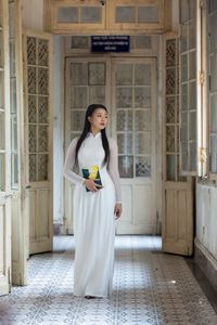 Graceful Vietnamese Girl in White Ao Dai by Window, Celebrating Traditional Beauty-9