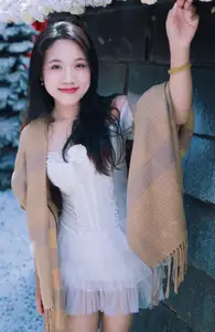 Radiant Beauty: Girl in Pristine White Dress Amidst Romantic Winter Wonderland 1000024890-0