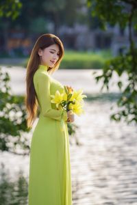 Serene Vietnamese Beauty: Woman in Ao Dai by the Lake-6
