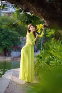 Serene Vietnamese Beauty: Woman in Ao Dai by the Lake-3
