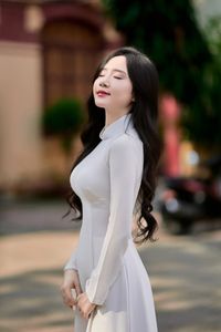 Captivating White Ao Dai: Elegant Vietnamese Girl in a Serene Moment, Timeless Beauty. Image ID: 1000019816.-6